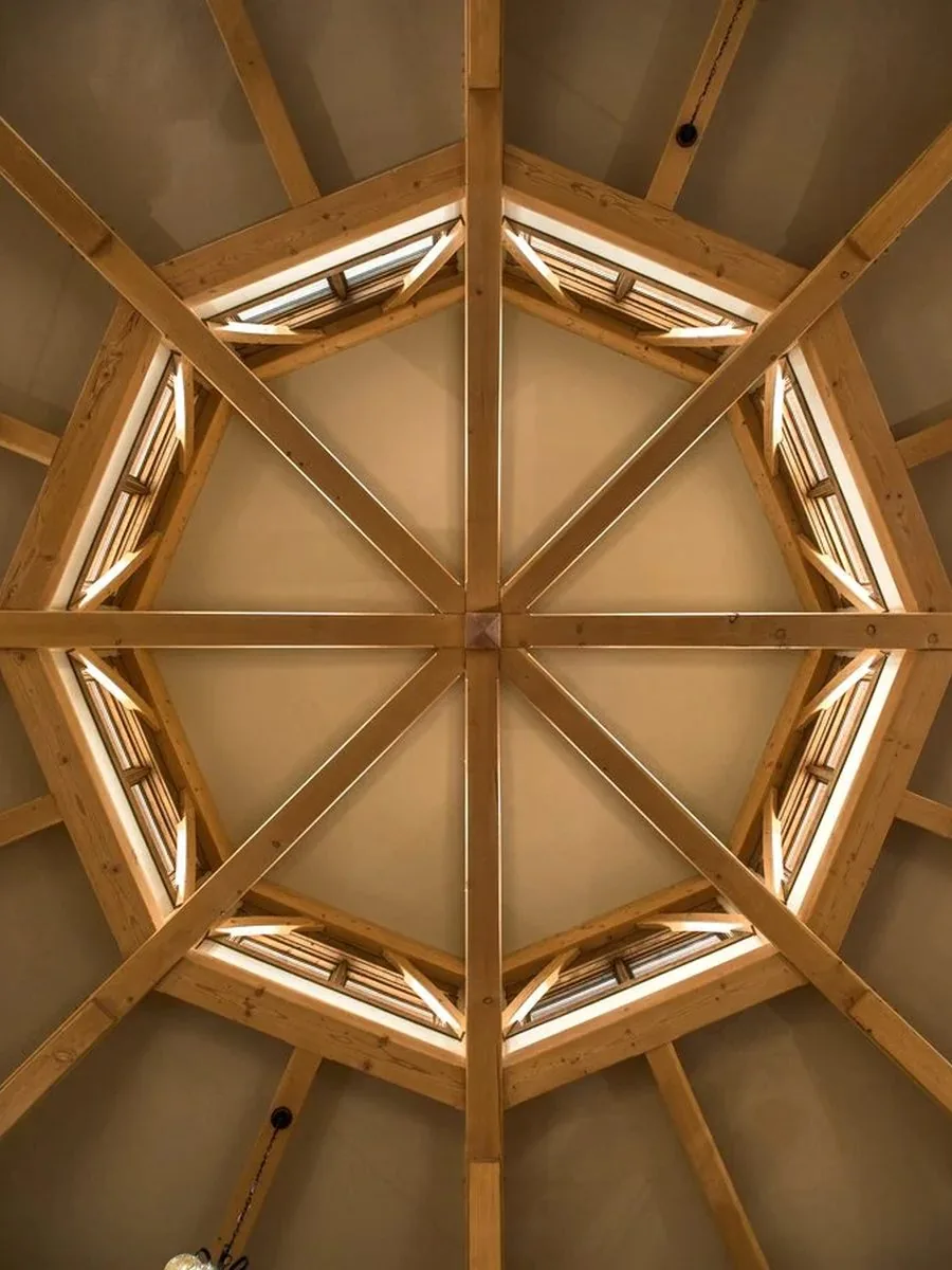 An octagonal timber ceiling seen from below, with glazing between each rafter